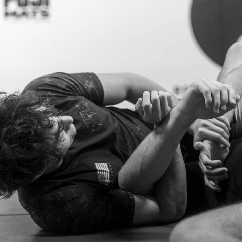 Jiu Jitsu and MMA Photography. Man submitting his opponent with an arm break.